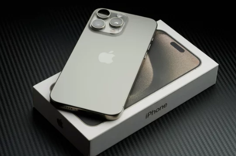 iPhone 15 Pro Max placed on its box, showcasing the sleek design and premium build, ready to sell.